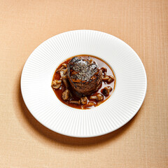 Filet mignon served with mushrooms side view