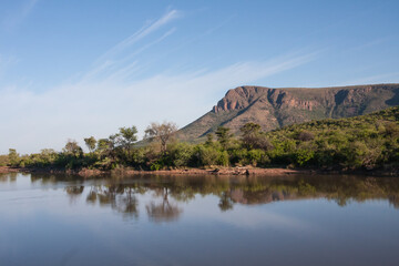 Fototapeta na wymiar Tlopi Dam scenic view with reflections in the water in Marakele National Park, Limpopo Province, South Africa