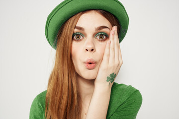 shamrock happy girl in a green hat and a t-shirt on a light background St. Patrick's Day