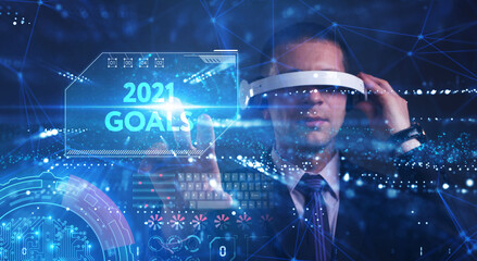 Business, Technology, Internet and network concept. Young businessman working on a virtual screen of the future and sees the inscription: 2021 goals