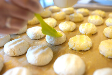 The process of making cheese cakes. Cheesecakes on a baking sheet before baking.