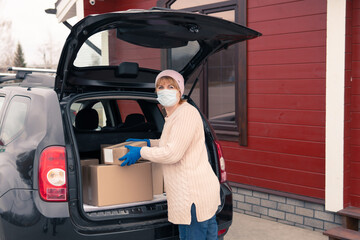 Woman Courier delivers cargo to the address by car