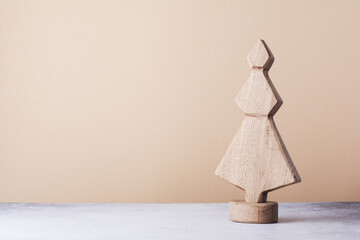 Wooden decorative Christmas tree on a light background. Zero waste concept..