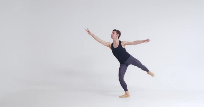 Elegant male, ballet dancer performs acrobatic elements of a ballet dance on a white background, 4k slow motion.