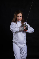 Teenage girl fencer dressed in uniform with epee and helmet