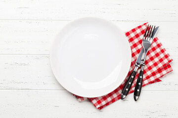 White empty plate, fork, knife and napkin