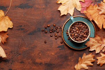 Coffee cup and autumn leaves