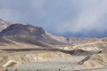 The badlands terrain of Death Valley National Park, as seen from Zabriskie Point, on a cloudy and stormy day