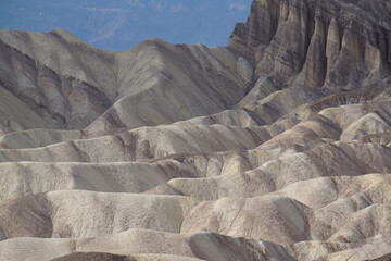 View of the lines, textures and shadows of the colorful badlands as seen from Zabriskie Point at Death Valley National Park