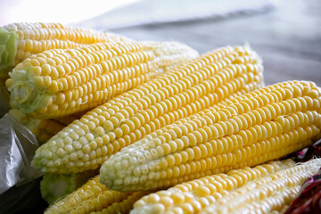 Close-up of corn peeled on the table.