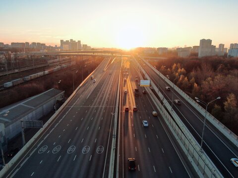 Aerial view panorama of multi-level transport interchange in the center of the big city at dawn. Beautiful panoramic landscape infrastructure of modern city from great height