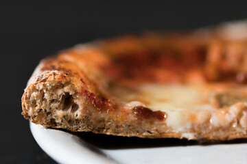 Extreme close up of pizza made with wholemeal flour. Diet and healthy concept. Gourmet dish on...