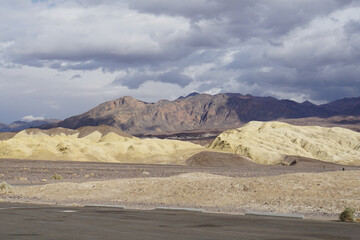Fototapeta na wymiar Wide open expanses and terrain at Death Valley National Park on a stormy and cloudy day
