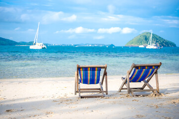 Beach bed on white sand and clear sea in the summer of Phuket Province, Thailand.