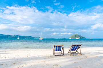 Beach bed on white sand and clear sea in the summer of Phuket Province, Thailand.
