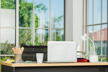 Back laptop computer putting on working desk