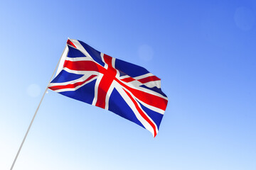 Flag of Great Britain waving against blue sky