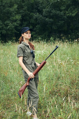 Woman Green jumpsuit black cap weapon hunting weapons