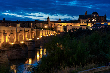 Mosque-Cathedral and the Roman Bridge in Cordoba, Andalusia, Spain at night