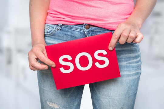Woman with incontinence problem with SOS on paper