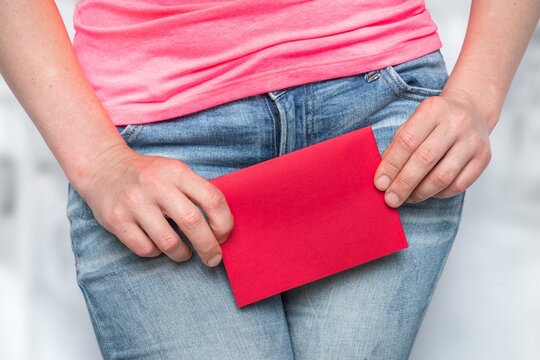 Woman with incontinence problem with red blank paper