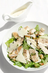 organic chicken caesar salad with parmesan cheese and croutons