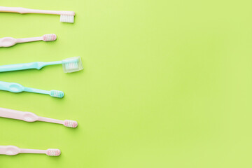 Toothbrushes on color background