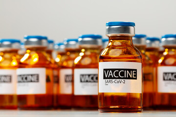 Sars-cov-2 vaccine vial bottles on white table