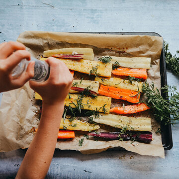 Woman Adding Spices On Fresh Vegetables In A Frying Pan