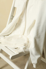 Fototapeta na wymiar Wooden chair with blank white sweatshirt and beanie