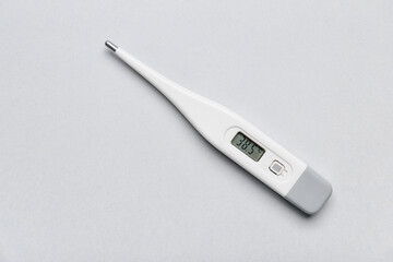 Electronic thermometer on light background