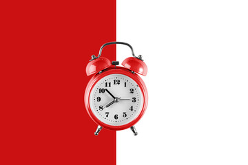 Old red alarm clock on red and white background. Creative flat lay vintage clock on color background, copy space in minimal style, empty template for text
