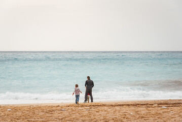 un homme est à plage avec ses enfants. Un père et ses enfants sur la plage. Un père seul avec ses enfants