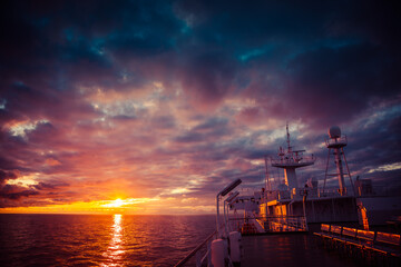 Obraz premium The ferry goes over the sea in the sunset