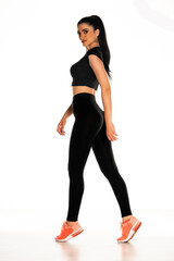Obraz premium beautiful young sporty woman walking on white