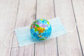 Globe and medical mask. Worldwide epidemic