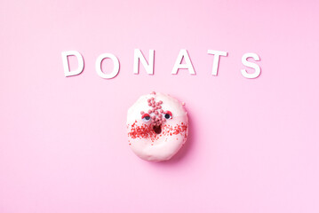 Sweet donuts with icing and text Donuts on pastel pink background. Top view. Copy space. No diet concept.