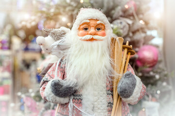 Santa Claus with gifts on the background of the Christmas tree
