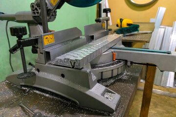 Aluminum profile on the machine for making slots. Aluminum profile with slits. Profile for multi-level stretch ceilings.