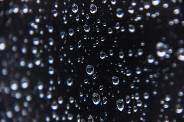 raindrops on glass close-up. water droplets on the surface in macro photography. abstract background