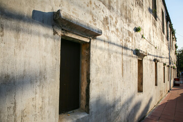 The wooden windows on the cement wall and the sunlight shone on the walls