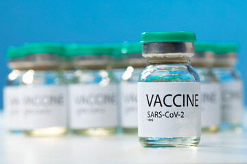 Sars-cov-2 vaccine vial bottles on white table