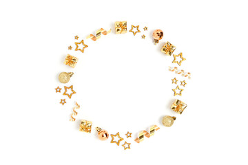 Wreath made of gold Christmas toys and confetti. Monochrome festive frame on a white background.