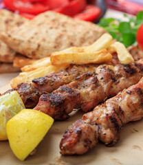 Grilled meat skewers on a table, closeup view