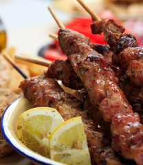 Grilled meat skewers on a table, closeup view