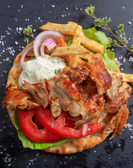 Gyros grilled meat slices on a pita bread, top view