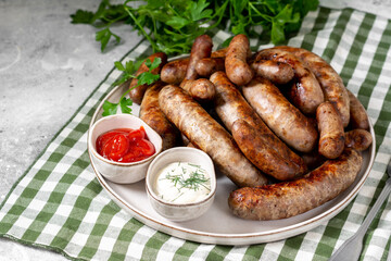 Fried sausages. Bavarian and Nuremberg sausages with spices, sauce, tomatoes and parsley. Delicious...