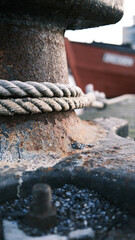 Fototapeta premium boat is attached to a steel bollard in the harbour with a large rope