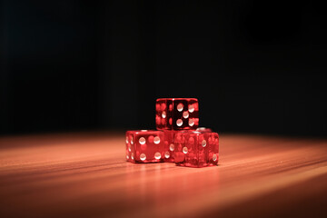 on a wooden plate there are 5 red dice next to each other