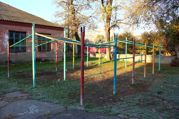 Children's painted playground, exercise equipment, horizontal bars for sports in the park